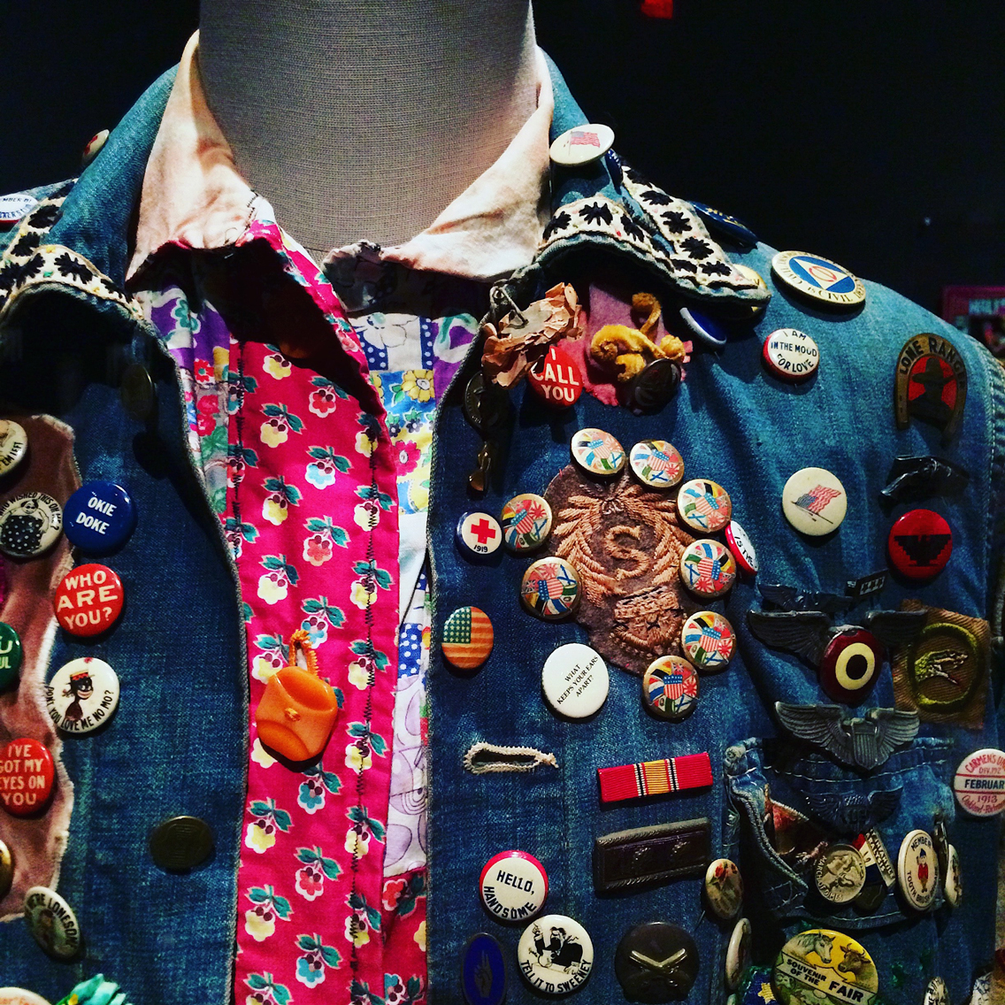 Denim jacket with badges on a vintage mannequin